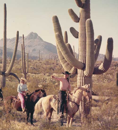 image: Don and Barbara on horseback in the desert.